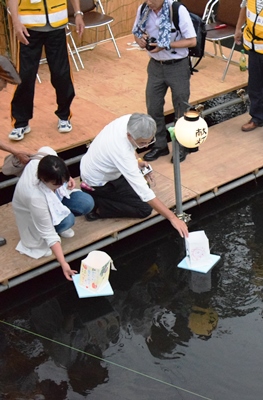 灯ろうを流す人の画像