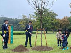 21世紀の森と広場来場者数2,000万人達成の記念植樹をしている様子